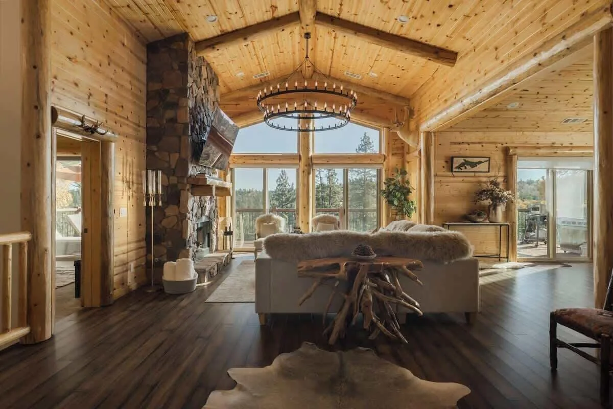 Vaulted great room with wood ceiling and stone fireplace