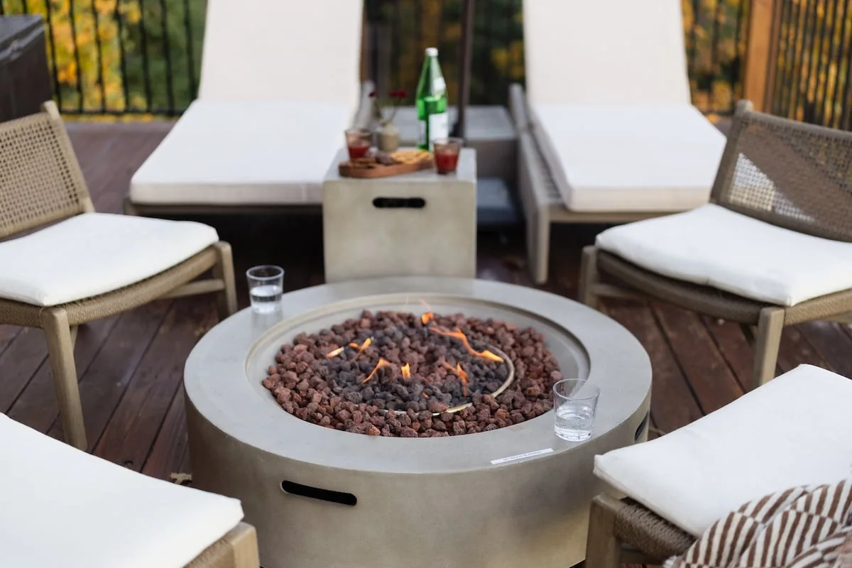 Close view of the propane fire pit and lounge chairs