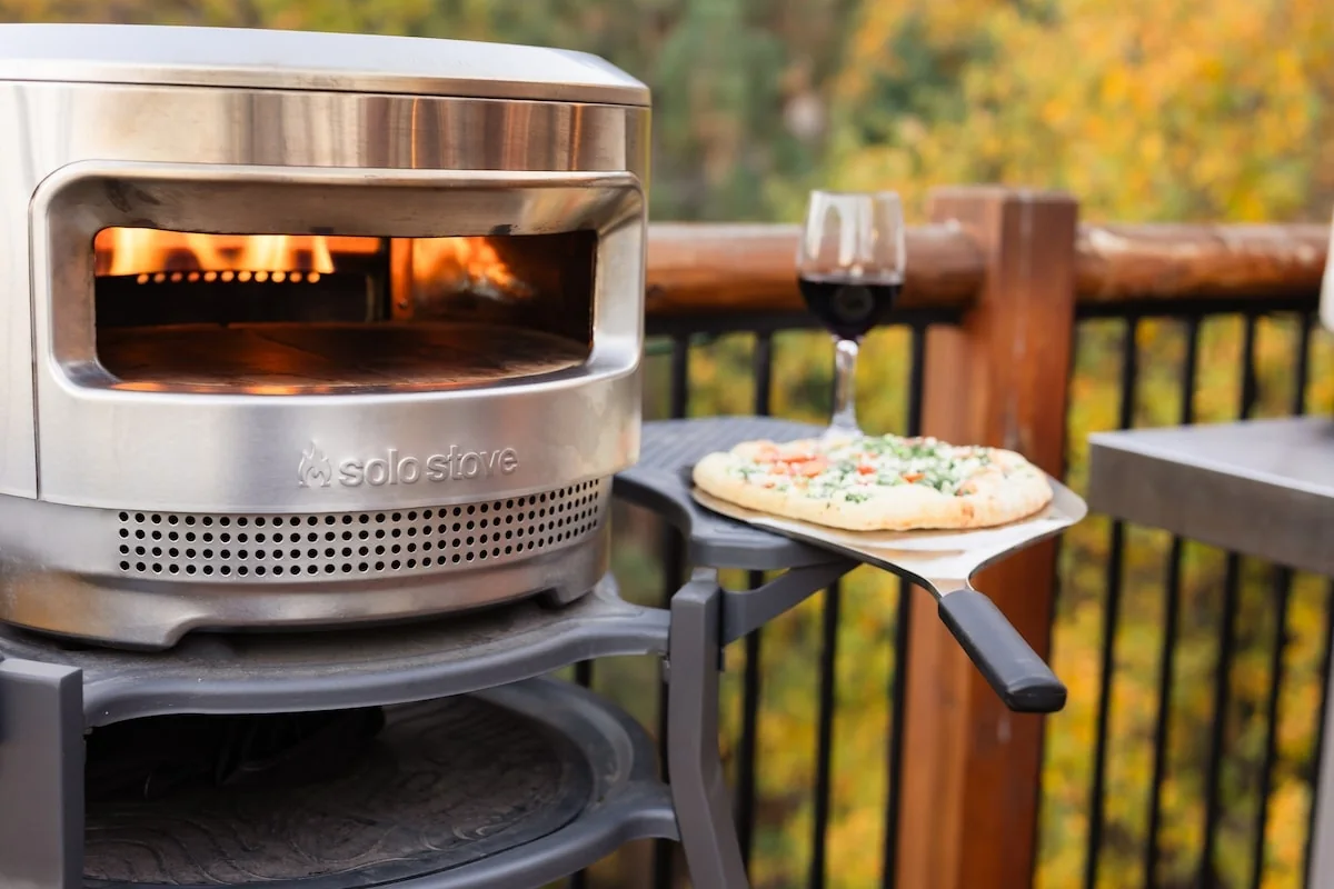 Solo Stove pizza oven with pizza on the mountain-view deck