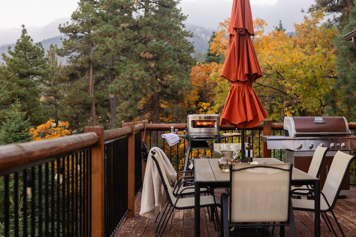 Outdoor dining table, pizza oven and BBQ on the deck