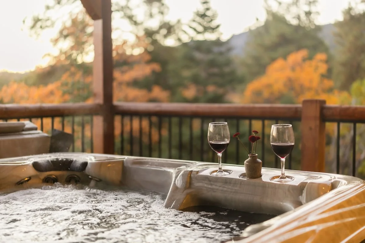 Bubbling hot tub overlooking autumn trees
