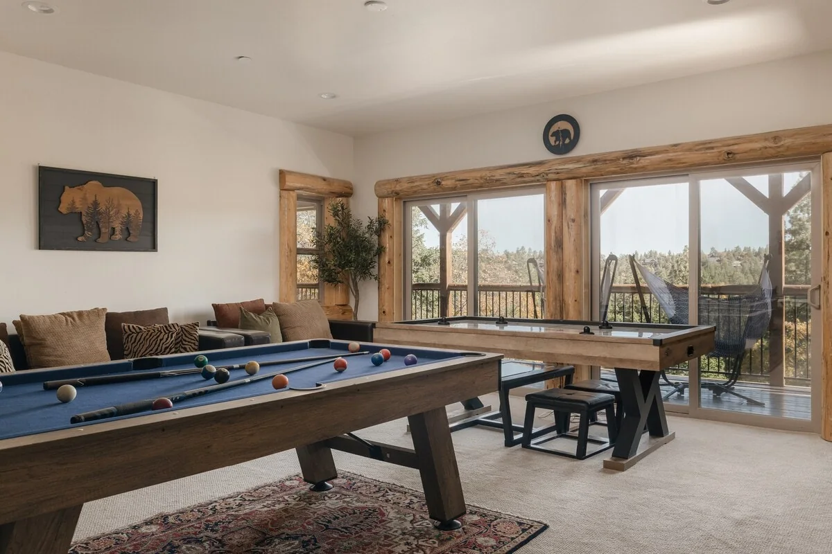 Wide view of the game room with billiards and air hockey tables
