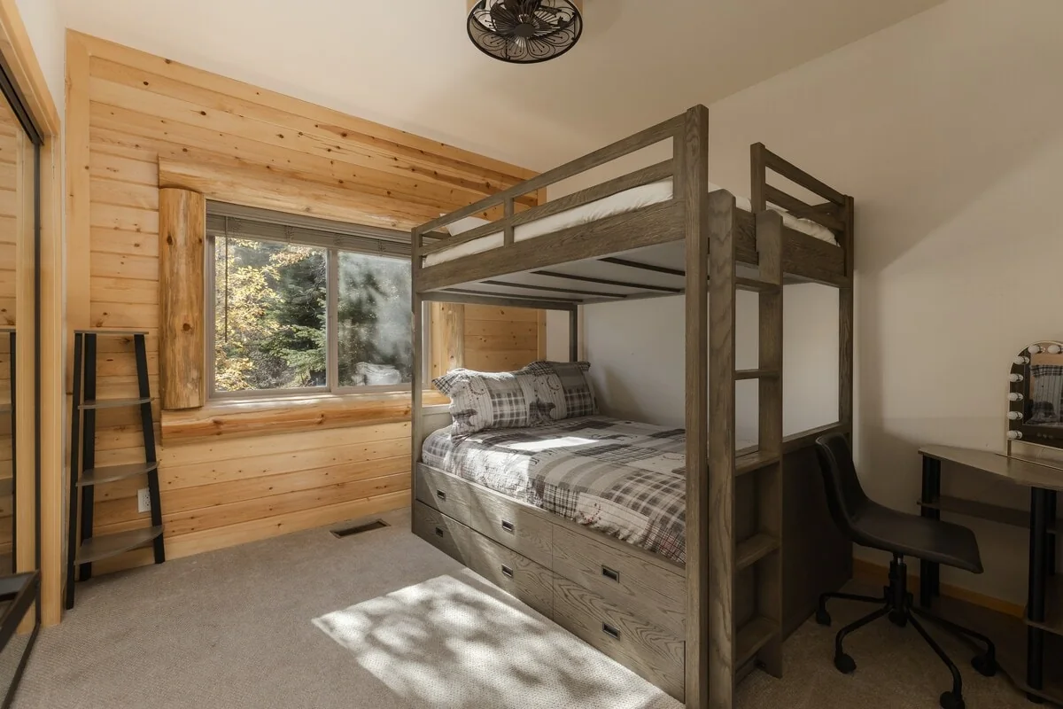 Guest bedroom with full bunk bed, trundle storage and desk